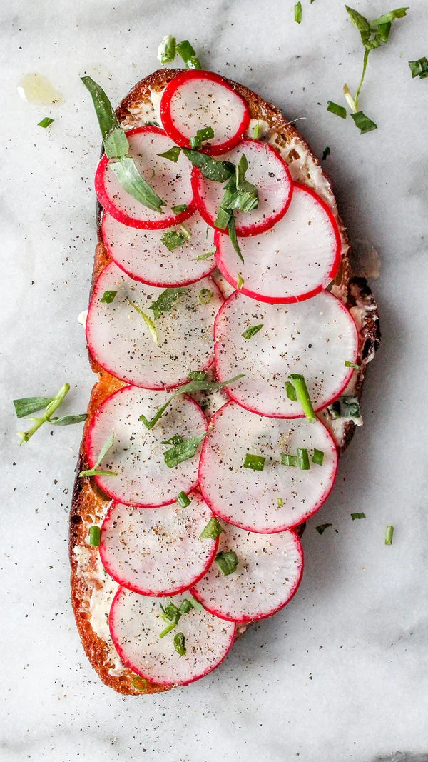 Herby butter and anchovy toast with radishes